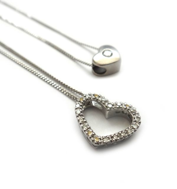 A white gold and diamond single stone heart shaped pendant, mounted with a circular cut diamond on white gold neckchain, with a boltring clasp, detail