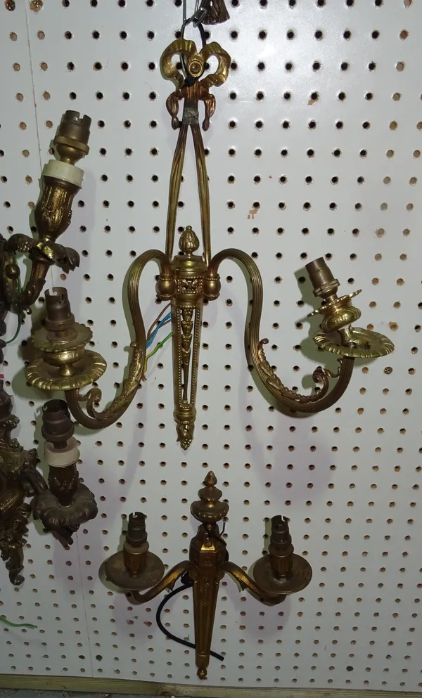Lighting comprising; a pair of 20th century gilt metal wall lights with ribbon surmounts and two further twin branch wall lights, (4)  H10