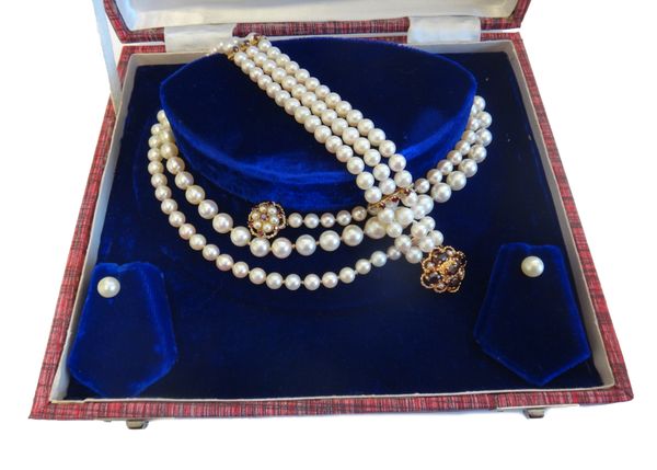 A single row necklace of graduated cultured pearls, on a gold, garnet and cultured pearl cluster clasp, detailed 9 CT, length 86cm, a three row bracel