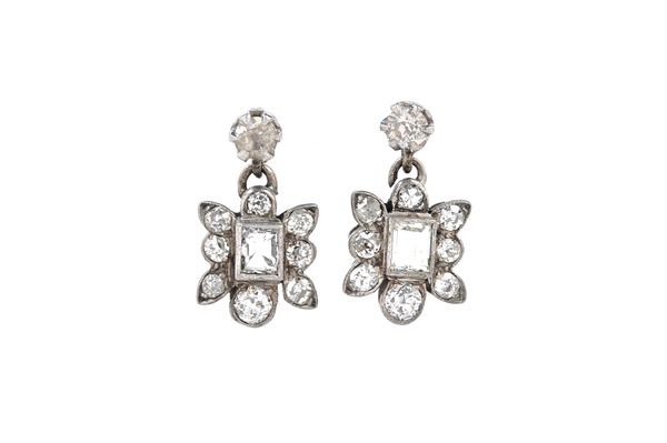 A pair of diamond set pendant earrings, each drop mounted with an emerald cut diamond at the centre, within a surround of eight smaller cushion shaped