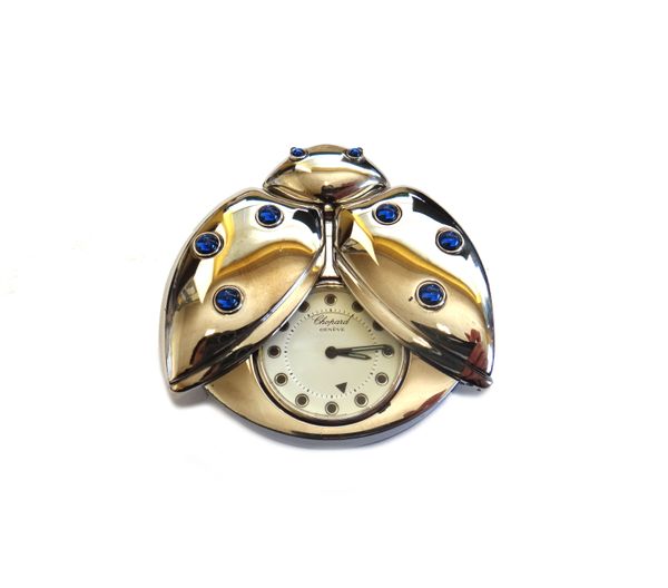 A Chopard rhodium plated metal and cabochon blue gem set folding travelling clock with an alarm, modelled as a winged insect, with folding wings, the