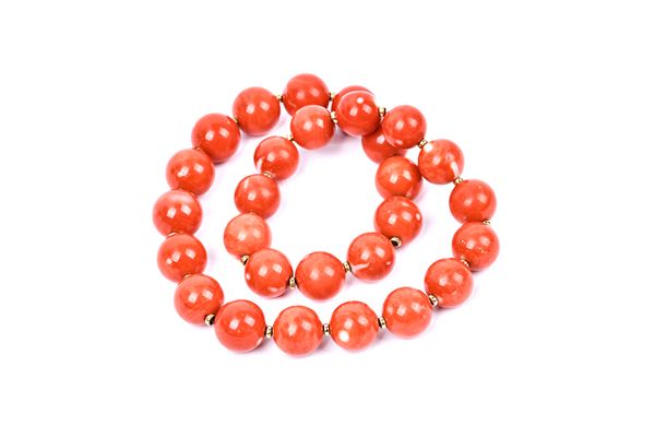 A single row necklace of treated uniform coral beads, on a twist action clasp, length 42.5cm.   Illustrated