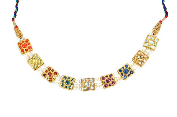 An Indian cabochon sapphire, cabochon ruby, coral and varicoloured gem set Navratan necklace, with square cluster settings and three-row pearl strung