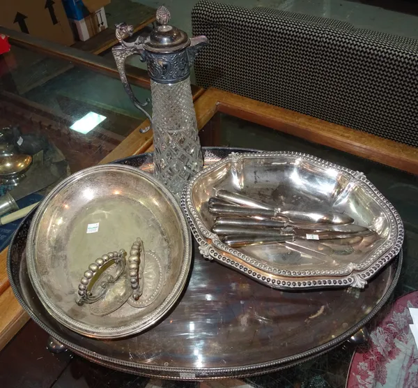 Silver plated ware, including; an oval galleried tray, claret jug, entree dishes, silver handled knives and sundry, (qty).  CAB