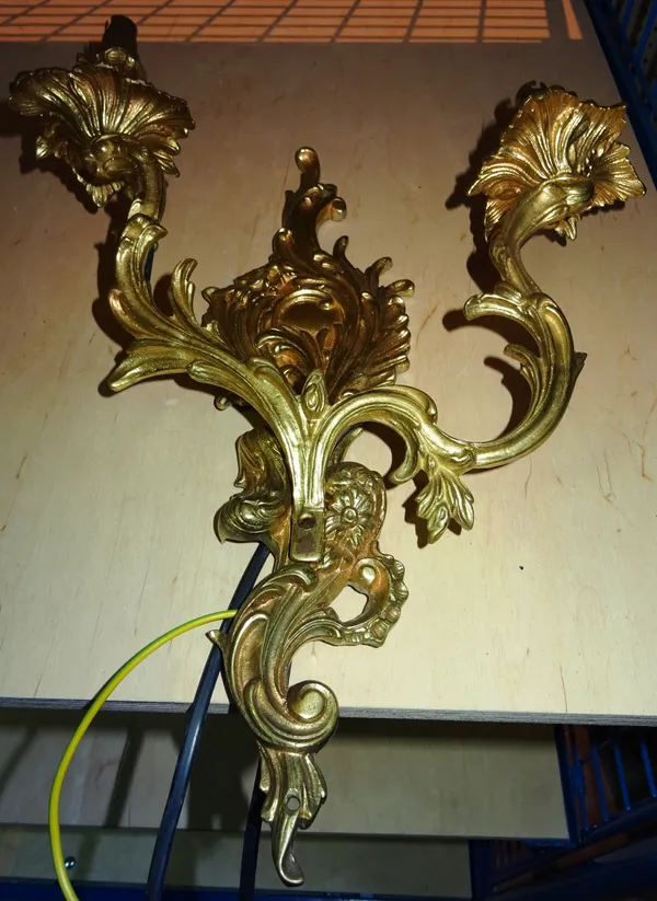 Lighting comprising; a group of five 20th century gilt metal twin branch wall lights of Rococo style, (5).     I10
