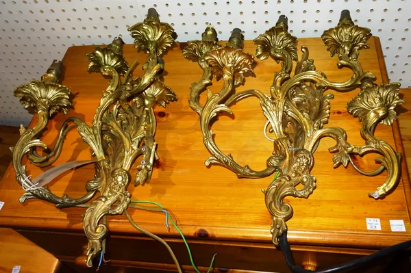Lighting comprising; a pair of 20th century five branch gilt metal wall lights in the Rococo style, (2).  J10