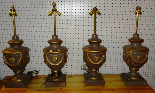 Lighting comprising; a set of four 20th century pottery table lamps of urn form and gilt swag decoration, (4). M10