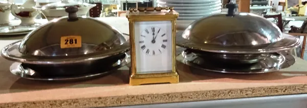 A pair of 20th century Keswick school beaten steel lidded bowls, and a brass cased carriage clock, (3).  S3T