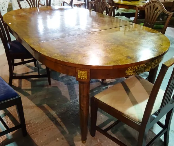 A 19th century burr walnut extending dining table with gilt metal mount decoration on tapering supports, + 1 extra leaf, 135cm wide x 75cm high x 200c