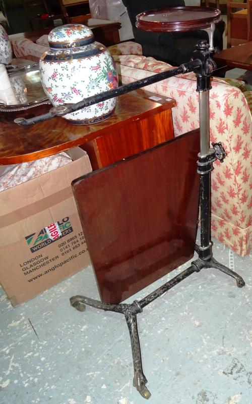 An early 20th century cast iron and mahogany adjustable reading stand, 60cm wide, (a.f).  I8