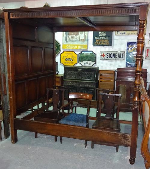 An 18th century style oak four poster bed with tapering turned columns and panelled back, 168cm wide x 210cm long x 240cm high.  C8
