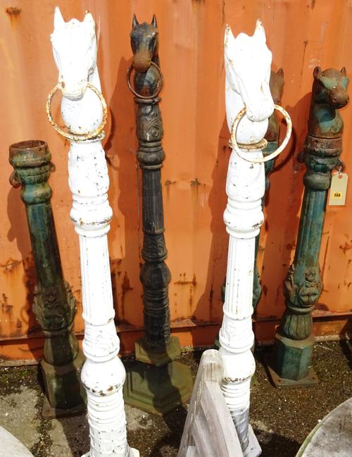 Garden statuary, including; a group of six early 20th century cast iron green and white painted horse tethers, approx 112cm high, (6).  OUT