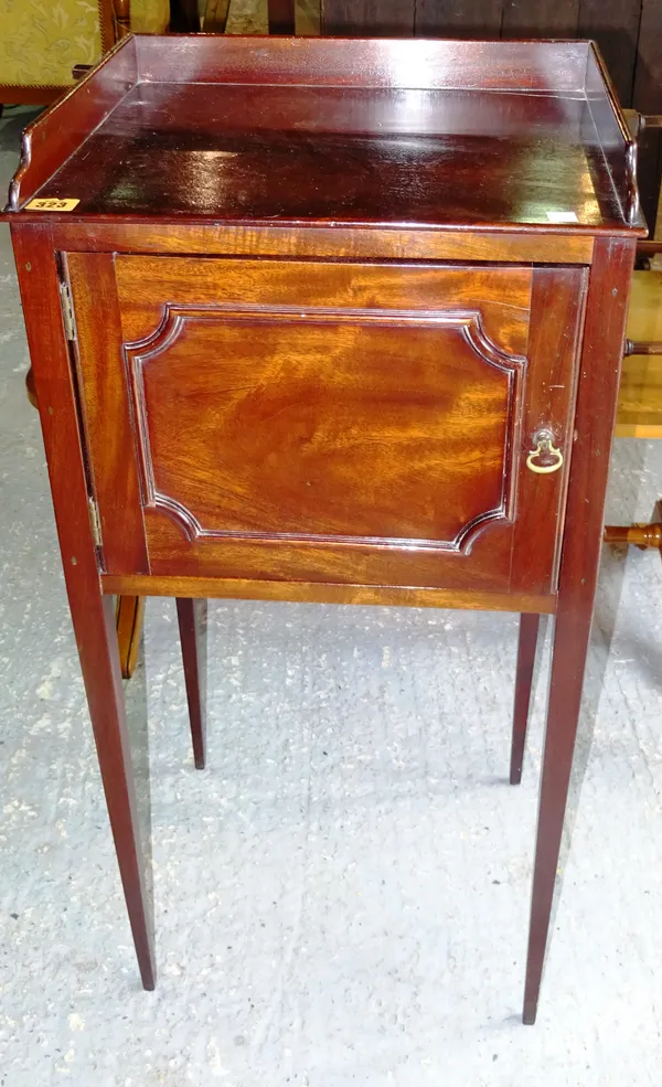 A 20th century mahogany night stand with single door and three quartered galleried top on square tapering supports, 42cm wide.   C10