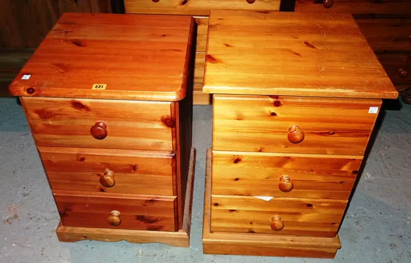 A pair of 20th century pine bedside chests with three short drawers 44cm wide x 62cm high and a 20th century pine chest of three long drawers 69cm wid