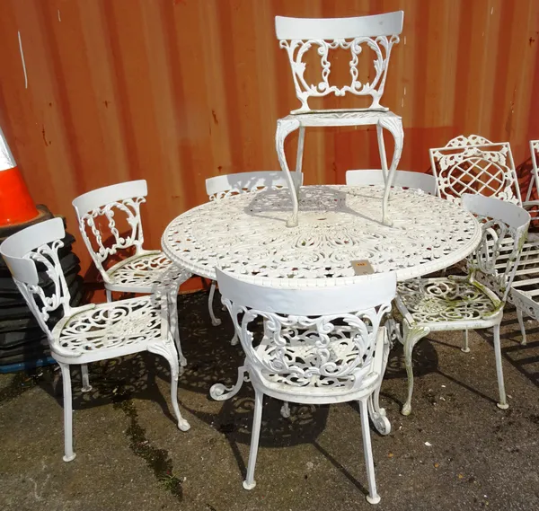 A 20th century white painted metal circular garden table, 120cm wide x 72cm high, with a set of seven chairs, (8).  OUT