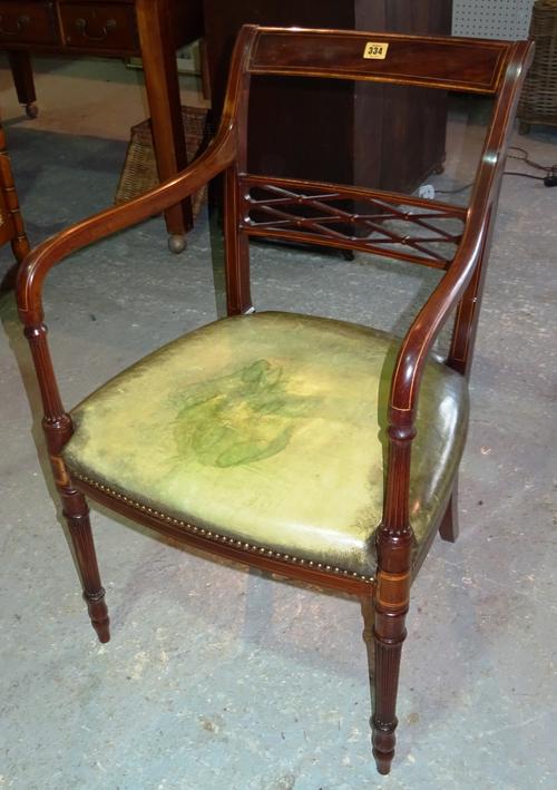 An Edwardian mahogany bar back open armchair, with studded leather seat, on fluted tapering supports.  D2