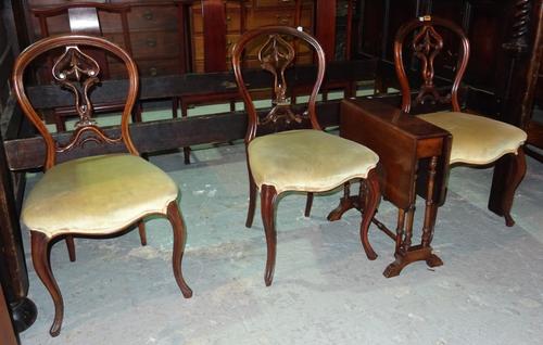 A set of three Victorian balloon back dining chairs, on cabriole supports, and a Victorian mahogany Sutherland table, 53cm wide x 57cm high, (4).  D9