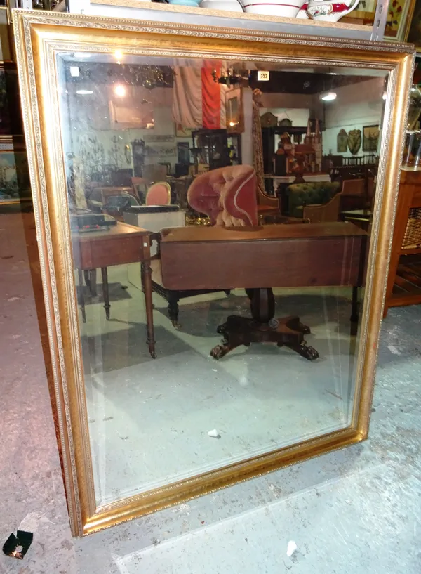 A 20th century gilt framed rectangular wall mirror, with bevelled glass, 116cm wide x 146cm high.  J2