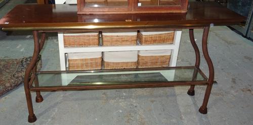 A 20th century metal console table, with mahogany top and brass edges, with glass undertier shelf, 140cm wide x 76cm high.  H3