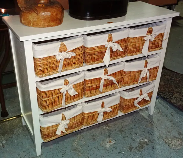 A 20th century white painted side table, with nine wicker drawers, 104cm wide x 84cm high.  H3