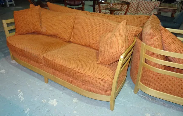 A pair of 20th century Ercol beech framed two seater sofas, on tapering block supports, 170cm wide x 72cm high, together with a matching armchair, (3)