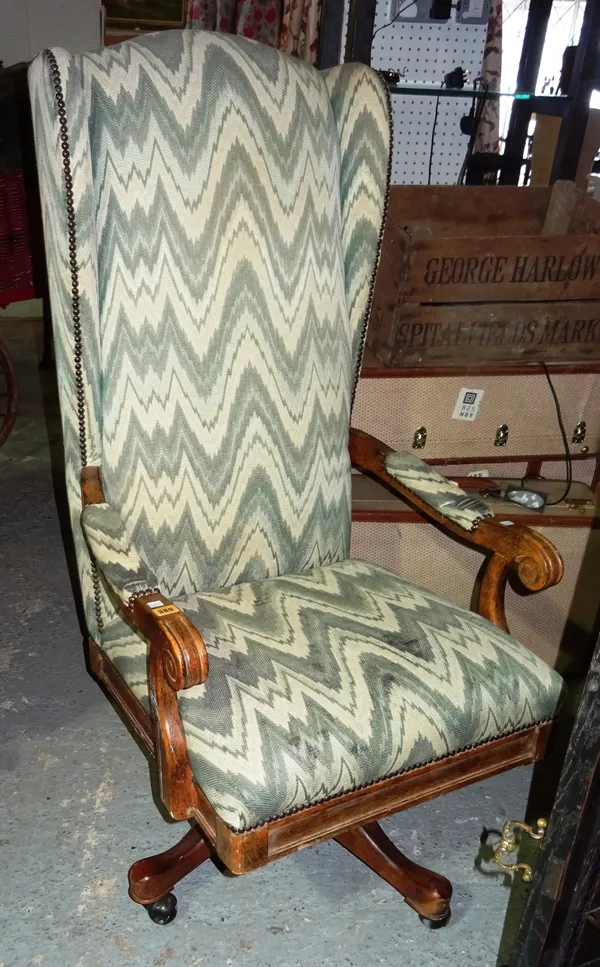 A 20th century oak, high back upholstered swivel office chair.  M3