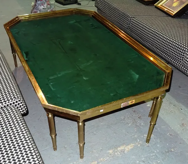 A 20th century brass coffee table, on fluted tapering supports, 131cm wide x 40cm high.  D3