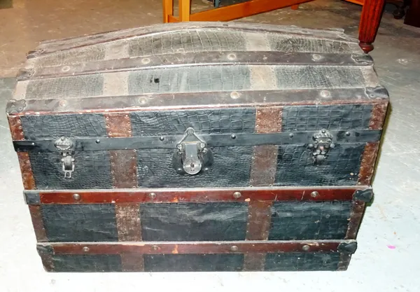 An early 20th century metal bound faux crocodile skin dome top trunk, 87cm wide x 61cm high. J5