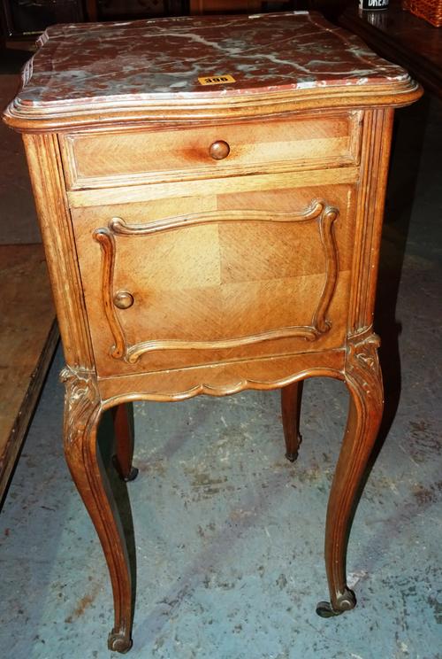 A Continental beech serpentine bedside stand, with marble top, on cabriole supports, 38cm wide x 85cm high.  K7