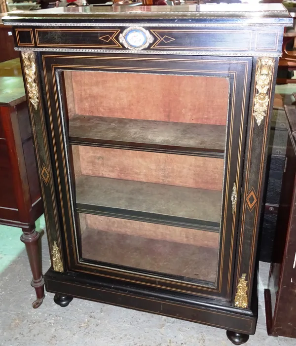 A Louis XVI style ebonised and gilt metal mounted pier cabinet, on tapering bun feet, 76cm wide x 106cm high.  G10