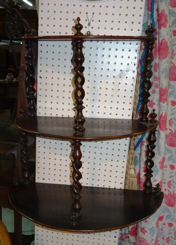 A Victorian rosewood three tier hanging wall shelf, with open barleytwist supports, 51cm wide x 71cm high.  D5