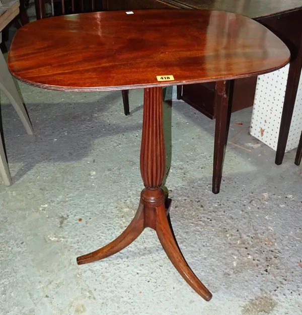 An early 19th century mahogany tilt top tripod table, with rounded rectangular top, reeded column and three splayed feet, 62cm wide.  M7