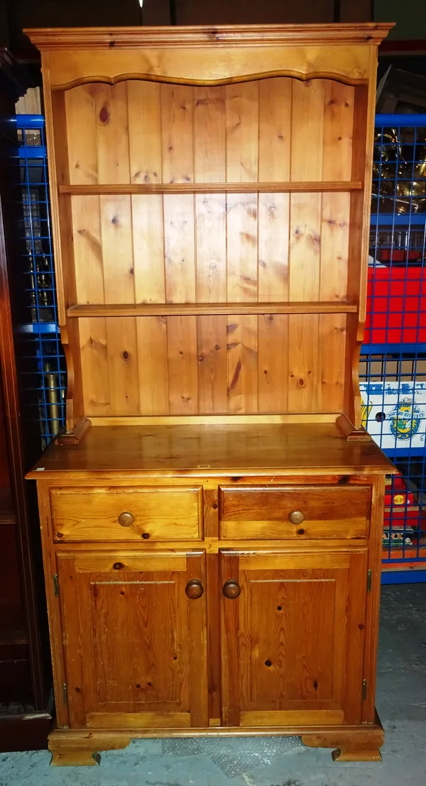 A 20th century pine dresser with a three tier plate rack, over cupboard base, 91cm wide x 200cm high.  M8