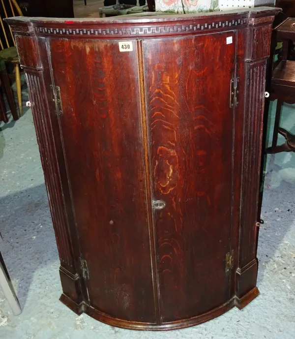 A George III oak corner cupboard, with fluted angles, 72cm wide x 95cm high.  J6