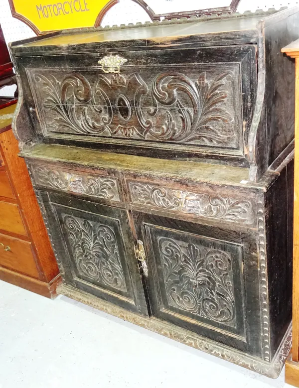 A late Victorian oak side cabinet, with fitted interior and carved panel doors, 106cm wide x 124cm high.  E10
