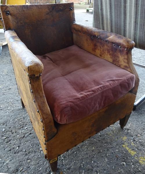 An early 20th century child's brown leather armchair.  M7