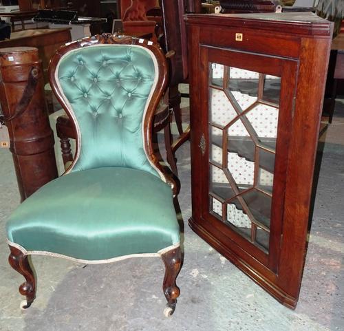 An early 20th century oak hanging corner cupboard, 64cm wide x 95cm high, together with Victorian spoon back nursing chair, (2).   J6