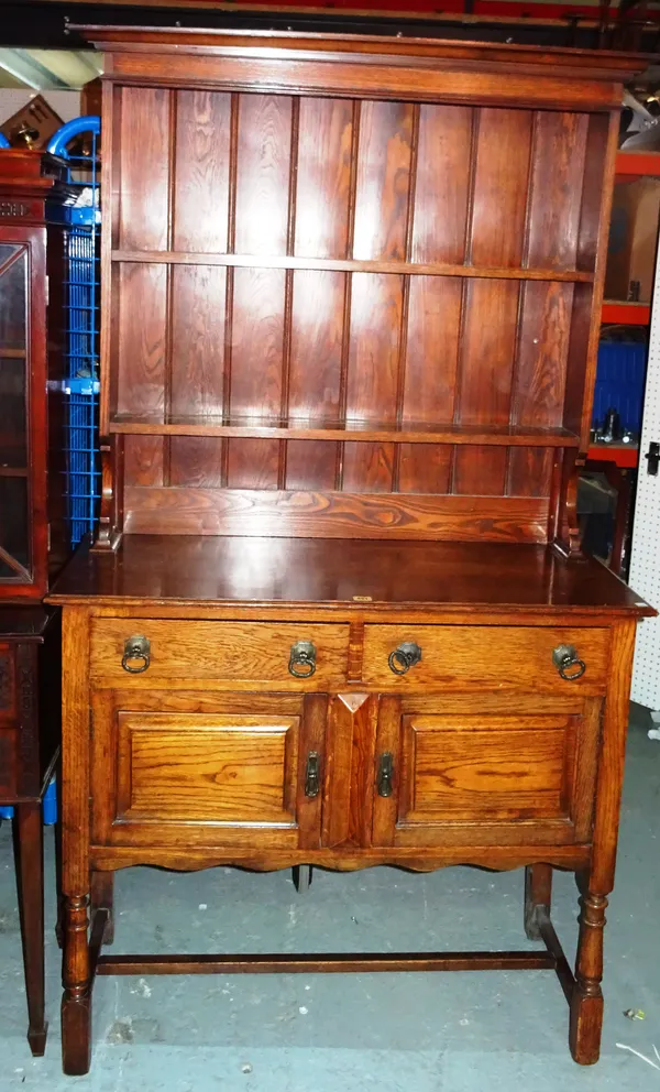 A 20th century oak dresser, with two tier plate rack on ring turned supports, 105cm wide x 188cm high.  M7