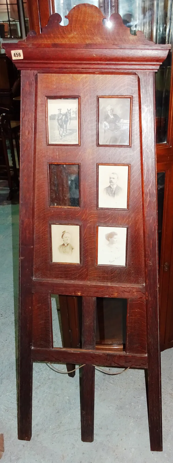 An early 20th century oak Arts and Crafts style seven section photograph frame, formed as an artist's easel, 150cm high.  M6