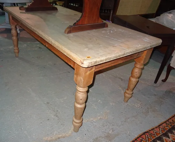 A 20th century pine kitchen table, on ring turned tapering supports, 183cm wide x 75cm high.  G8