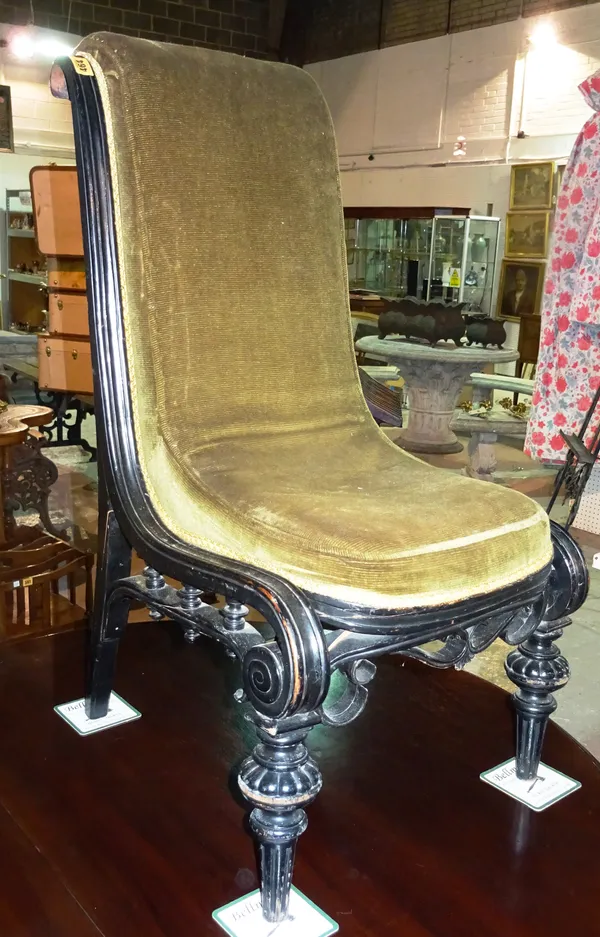 A Victorian ebonised nursing chair, on fluted tapering supports.  H6