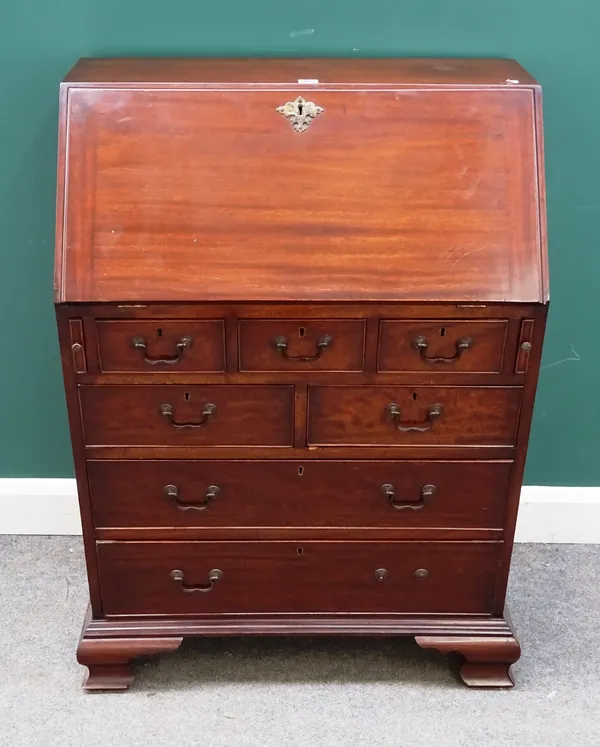 A small George III style mahogany bureau, the fitted interior over three short, two short and two long drawers, on ogee bracket feet, 77cm wide x 108c