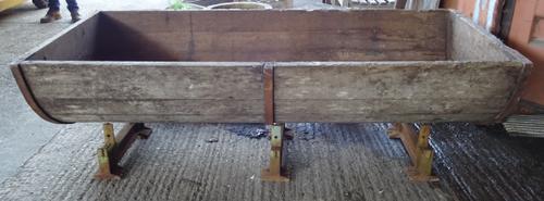 An early 20th century oak iron bound dough bin, on three cast iron supports, 175cm wide x 60cm high.  OUT