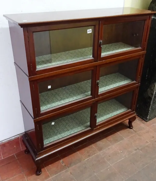 An early 20th century mahogany display cabinet, with three rows of glazed doors, on square cabriole supports, 103cm wide x 108cm high x 29cm deep.  K7