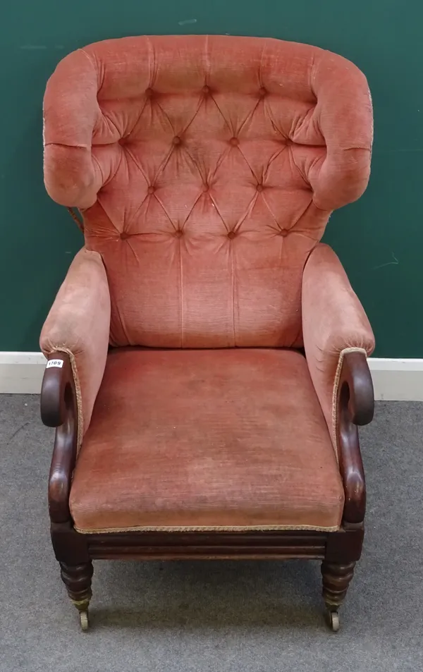 An early Victorian mahogany framed wingback armchair, with integral footstool in the manner of Dawes, pale pink button upholstery, scroll over arms, a
