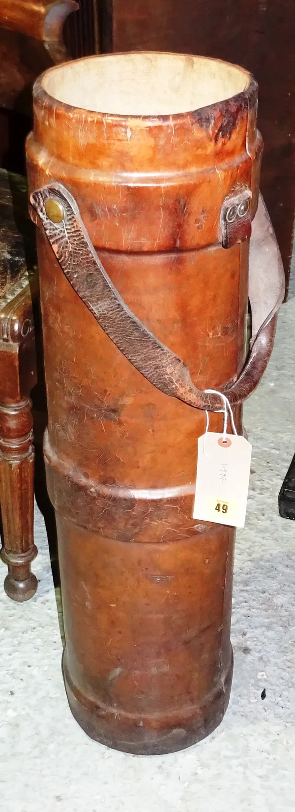A 19th century brown leather cylindrical shot carrier, 81cm high x 21cm wide. H2