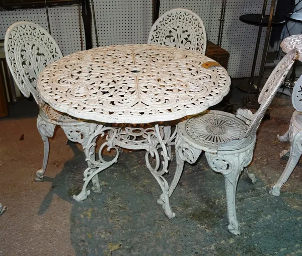 A 20th century white painted metal garden table, 91cm wide x 69cm high and a set of three cast iron white painted chairs, (4).  B6