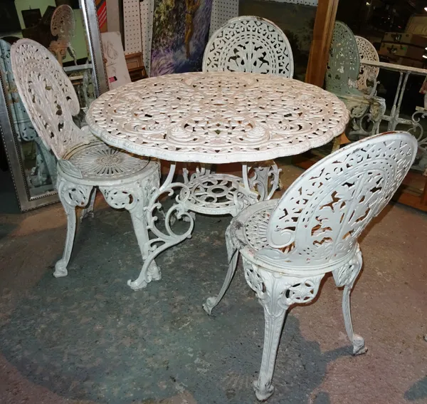 A 20th century white painted metal garden table, 91cm wide x 69cm high and a set of three cast iron white painted chairs, (4).  D6
