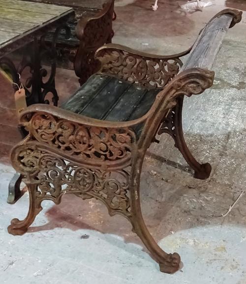 An early 20th century cast iron garden suite comprising; a bench 146cm wide x 78cm high and two matching armchairs, 71cm wide x 79cm high. F5