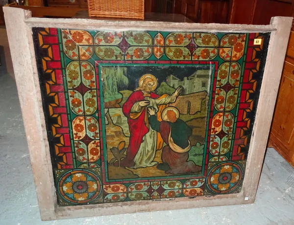 An early 20th century reverse painted glass panel depicting a religious scene, 108cm wide. M10